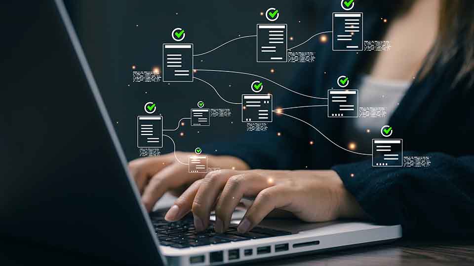 Person typing on laptop with digital document workflow icons and green checkmarks floating above