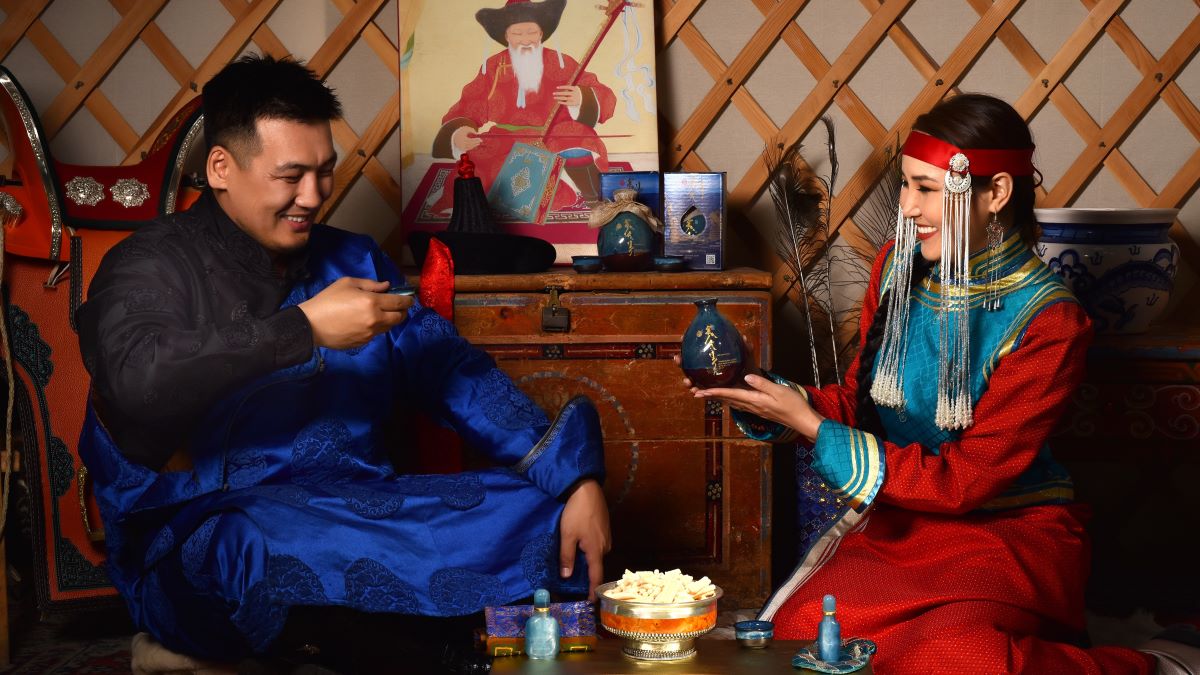 A man and a woman drinking Shimiin Okhi yak milk wine