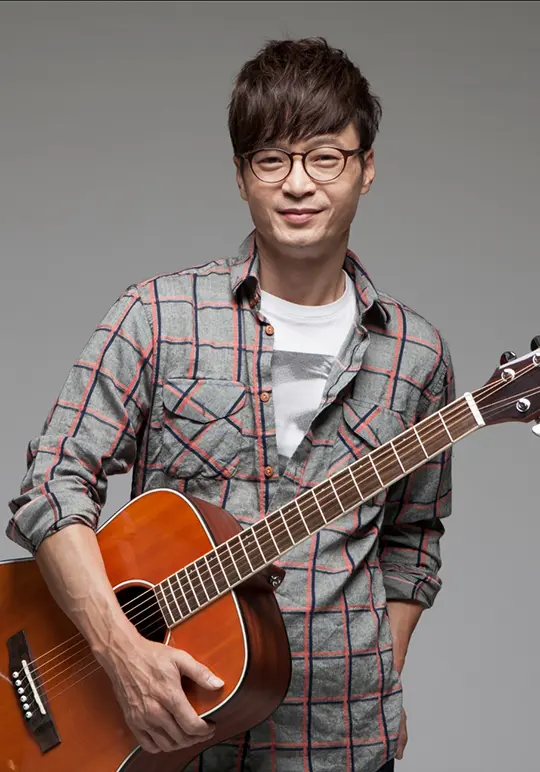 Haki Park standing with his guitar