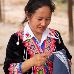 Mo, a hill tribe villager working on her next masterpiece