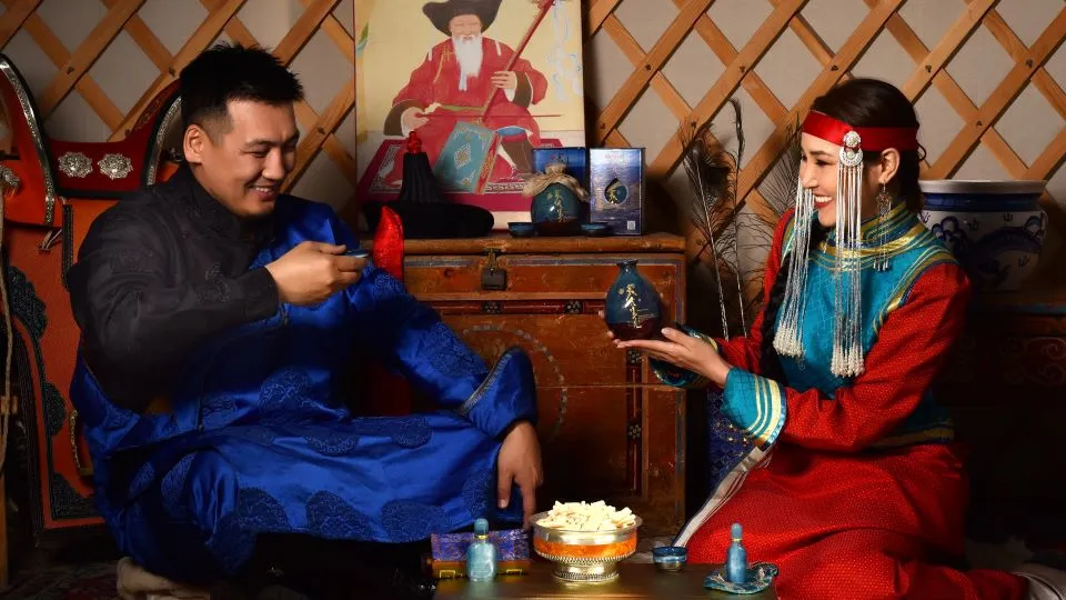 A man and a woman drinking Shimiin Okhi yak milk wine