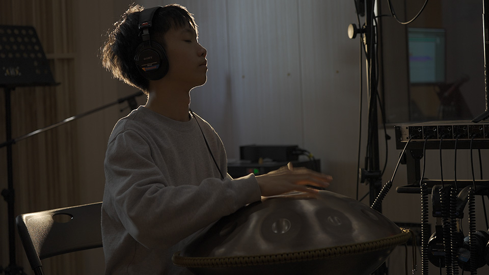 Boy in a studio playing the