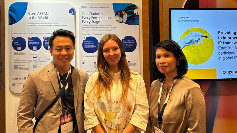 Mr. Marvin Jareth Chia and Ms. Aileen Umali poses with a visitor at WIPO Booth