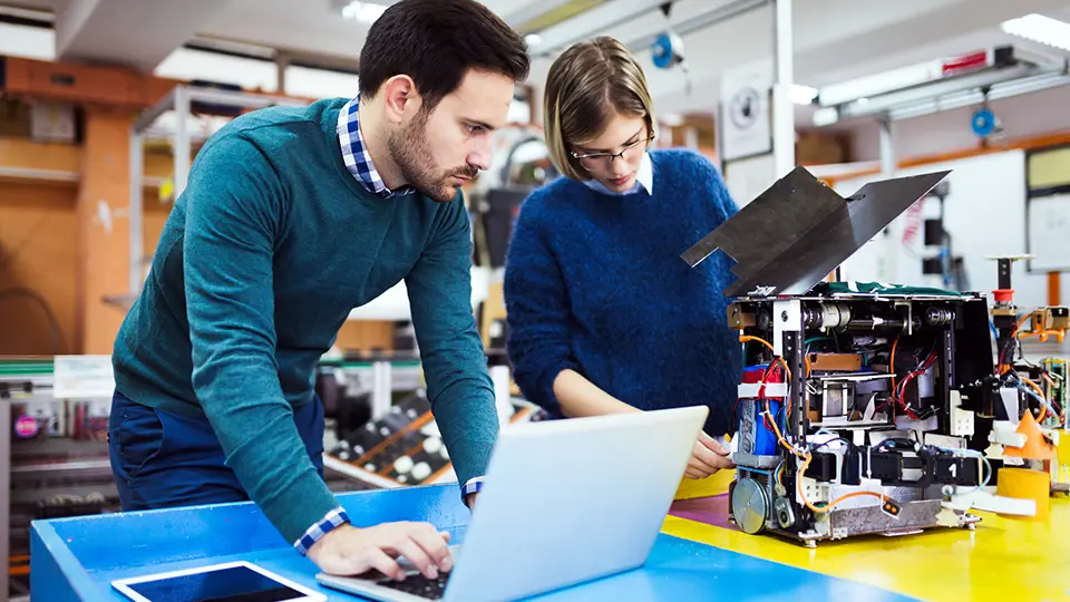 Young student of robotics working on project