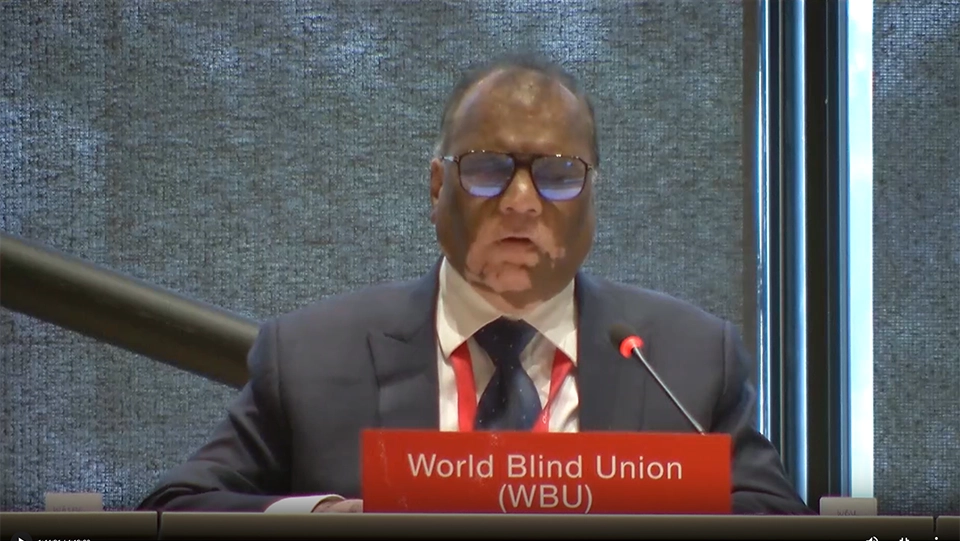 Mr. Santosh Kumar Rungta delivering a statement during the Marrakesh Assembly, speaking into a microphone from the conference hall, with the World Blind Union nameplate displayed in front of him.