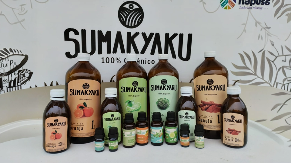 Display of Sumak Yaku organic essential oils and natural products on a table.